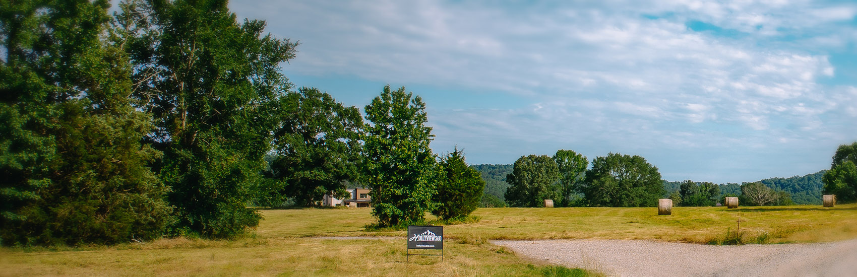 Hollyview360 sign with cabin in background